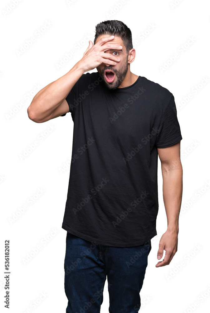 Young handsome man over isolated background peeking in shock covering face and eyes with hand, looking through fingers with embarrassed expression. Young handsome man over isolated background peeking in shock covering face and eyes with hand, looking through fingers with embarrassed expression.