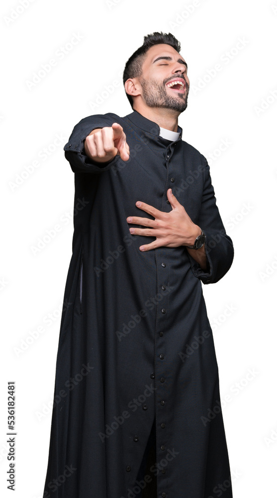 Young Christian priest over isolated background Laughing of you, pointing to the camera with finger hand over chest, shame expression Young Christian priest over isolated background Laughing of you, pointing to the camera with finger hand over chest, shame expression