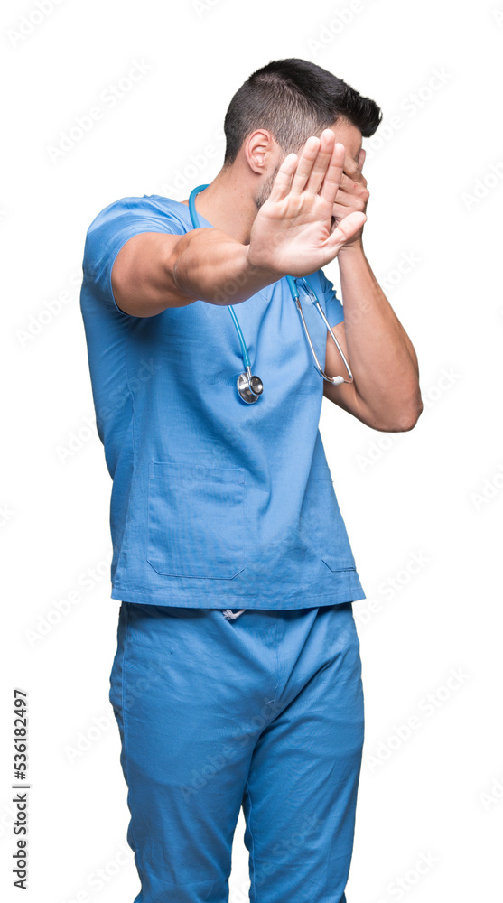 Handsome young doctor surgeon man over isolated background covering eyes with hands and doing stop gesture with sad and fear expression. Embarrassed and negative concept. Handsome young doctor surgeon man over isolated background covering eyes with hands and doing stop gesture with sad and fear expression. Embarrassed and negative concept.