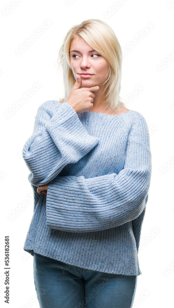 Young beautiful blonde woman wearing winter sweater over isolated background with hand on chin thinking about question, pensive expression. Smiling with thoughtful face. Doubt concept. Young beautiful blonde woman wearing winter sweater over isolated background with hand on chin thinking about question, pensive expression. Smiling with thoughtful face. Doubt concept.
