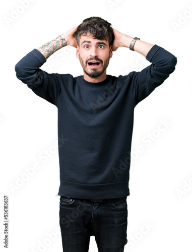 Young handsome man over isolated background Crazy and scared with hands on head, afraid and surprised of shock with open mouth