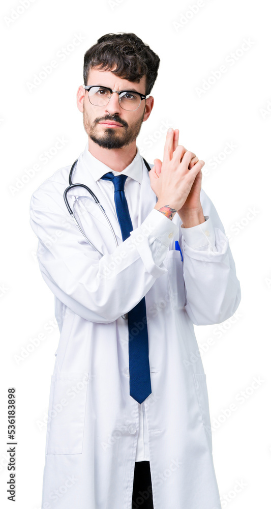 Young doctor man wearing hospital coat over isolated background Holding symbolic gun with hand gesture, playing killing shooting weapons, angry face Young doctor man wearing hospital coat over isolated background Holding symbolic gun with hand gesture, playing killing shooting weapons, angry face