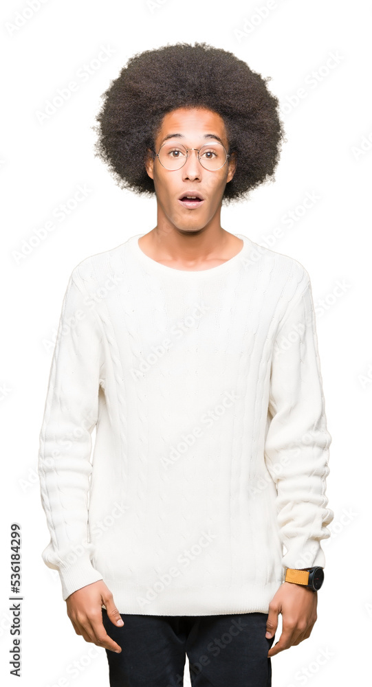 Young african american man with afro hair wearing glasses afraid and shocked with surprise expression, fear and excited face. Young african american man with afro hair wearing glasses afraid and shocked with surprise expression, fear and excited face.