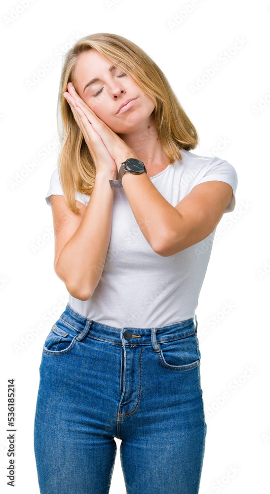 Beautiful young woman wearing casual white t-shirt over isolated background sleeping tired dreaming and posing with hands together while smiling with closed eyes. Beautiful young woman wearing casual white t-shirt over isolated background sleeping tired dreaming and posing with hands together while smiling with closed eyes.