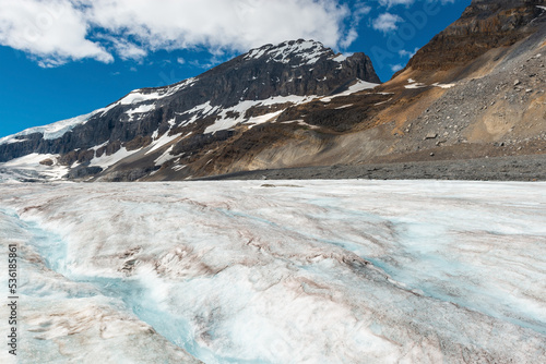 Athabasca glacier with melting water forming a small river, Jasper national park, Alberta, Canada. photo