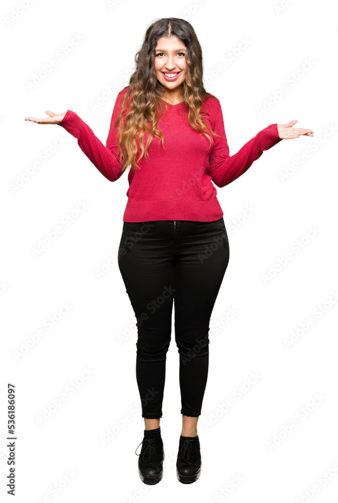 Young beautiful woman wearing red sweater Smiling showing both hands open palms, presenting and advertising comparison and balance Young beautiful woman wearing red sweater Smiling showing both hands open palms, presenting and advertising comparison and balance
