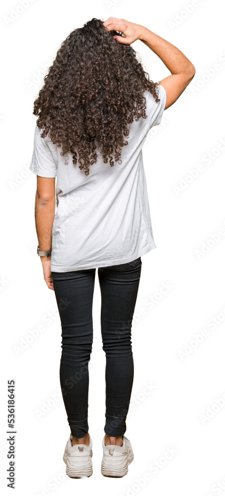 Young beautiful woman with curly hair wearing white t-shirt Backwards thinking about doubt with hand on head Young beautiful woman with curly hair wearing white t-shirt Backwards thinking about doubt with hand on head