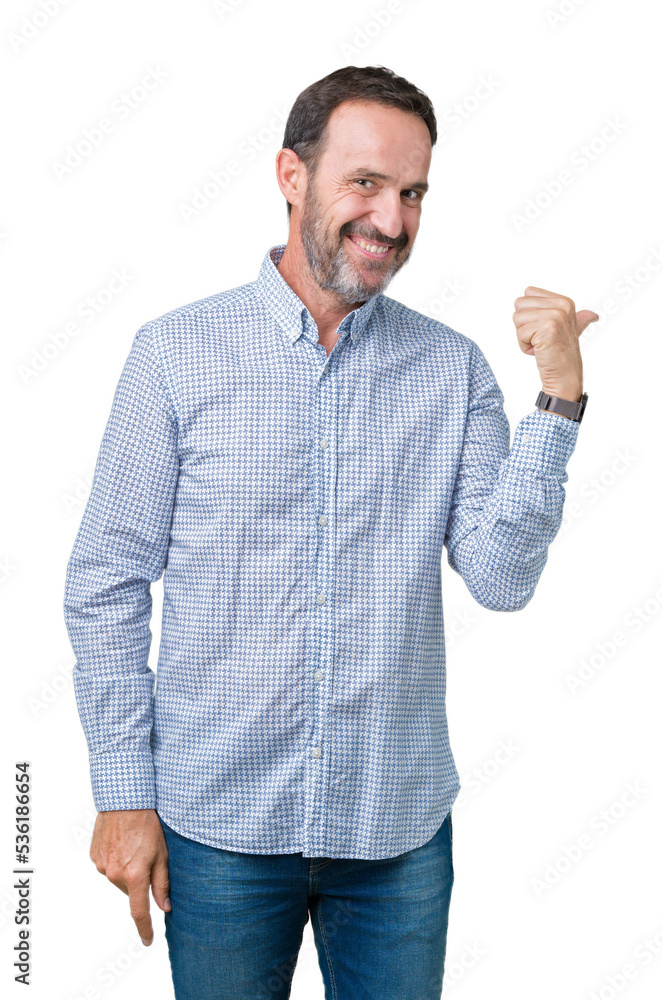 Handsome middle age elegant senior man over isolated background smiling with happy face looking and pointing to the side with thumb up. Handsome middle age elegant senior man over isolated background smiling with happy face looking and pointing to the side with thumb up.