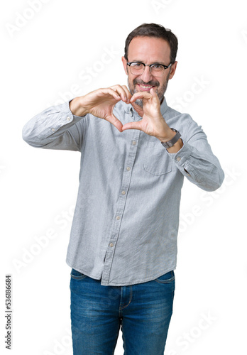 Handsome middle age elegant senior man wearing glasses over isolated background smiling in love showing heart symbol and shape with hands. Romantic concept.