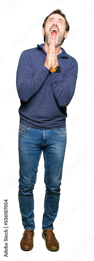 Middle age handsome man wearing a sweater begging and praying with hands together with hope expression on face very emotional and worried. Asking for forgiveness. Religion concept. Middle age handsome man wearing a sweater begging and praying with hands together with hope expression on face very emotional and worried. Asking for forgiveness. Religion concept.