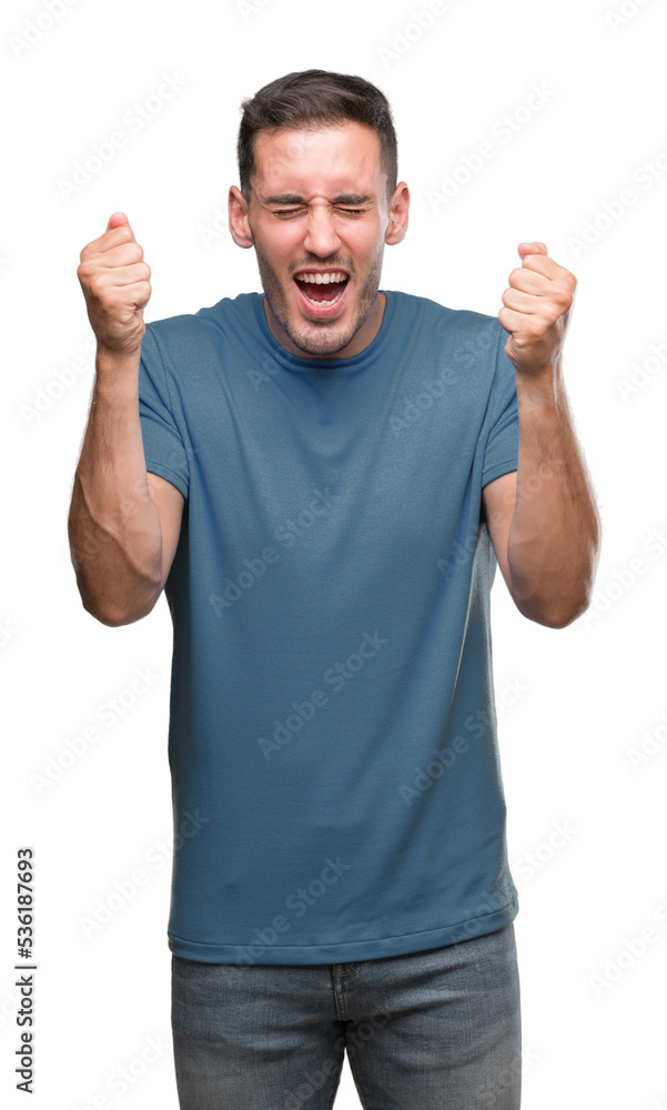 Fototapeta premium Handsome young casual man excited for success with arms raised celebrating victory smiling. Winner concept.