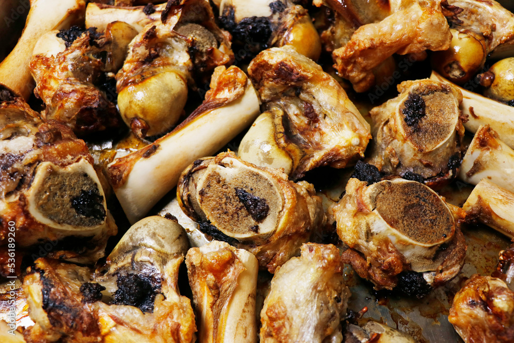 roasted veal marrow bone or beef bone from the oven for stock or sauce preparation roasted veal marrow bone or beef bone from the oven for stock or sauce preparation