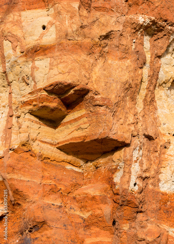 Sedimentary rocks with a high content of iron oxide. Red soil, loam. The texture of the soil.