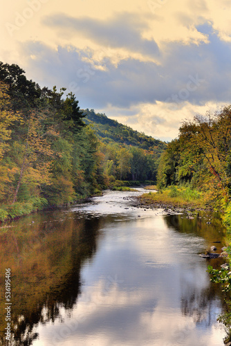 The Williams River slicing through the picturesque New England countryside while providing reflections of its surroundings in early autumn. 