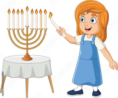 Happy jewish girl lights hanukkah candles