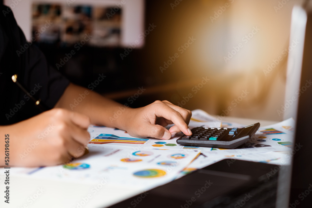 Businessman using calculator with planning  business, idea for marketing to project success. Business people analysis data figures to plan business strategies. Business plan growth concept.