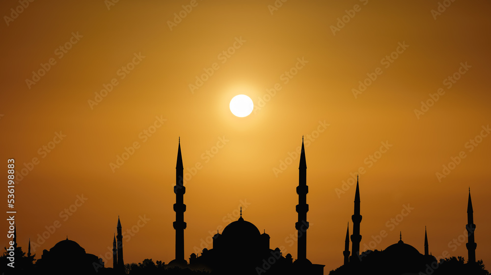  silhouette islamic mosque with domes and towers with background of sunrising