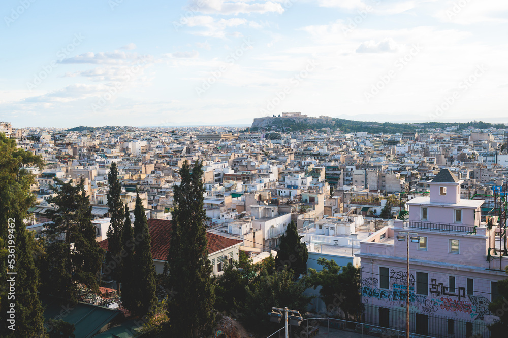 Fototapeta premium Athens, Attica, beautiful super-wide angle view of Athens, Greece, with Acropolis, Mount Lycabettus, mountains and scenery beyond the city, seen from Strefi Hill park in Exarcheia neighbourhood