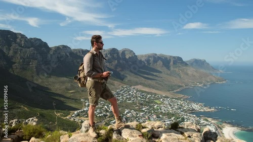 Landscape with Table mountain at sunrise. Cape Town South Africa, overlooking Table Mountain and Lions Head. a male traveler stands on the peak of a lion's head mountain in cape town, south africa photo