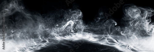 Real smoke exploding outwards with empty center. Dramatic smoke or fog effect for spooky Halloween background.
