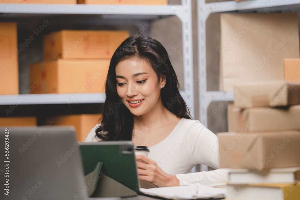 Asian woman e-business entrepreneur checking order and packing parcel box of product shipping delivery business, freelance marketing owner having online cyberspace to work with logistic package job Asian woman e-business entrepreneur checking order and packing parcel box of product shipping delivery business, freelance marketing owner having online cyberspace to work with logistic package job