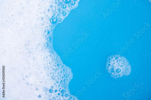 Detergent foam bubble, blue background. © Bowonpat