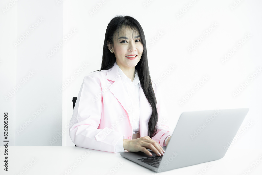 Asian woman doctor using computer laptop on white background, Asian woman doctor in pink coat with computer laptop, Medical and healthcare working diagnosing examination health. Asian woman doctor using computer laptop on white background, Asian woman doctor in pink coat with computer laptop, Medical and healthcare working diagnosing examination health.