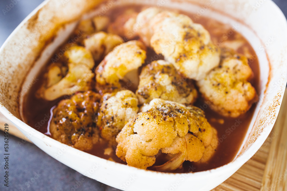 healthy plant-based food, vegan roasted cauliflower in spicy sauce healthy plant-based food, vegan roasted cauliflower in spicy sauce
