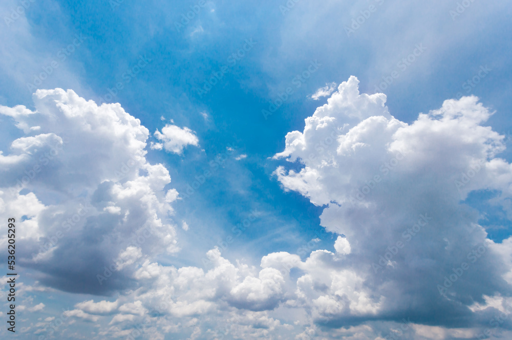 Fototapeta premium The vast sky and the white clouds float in the sky. The natural blue background has a breeze on a bright day in the summer.The sky and clouds are not the same shape as the weather.