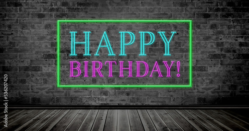 Photography Composite of happy birthday text in rectangle box over wooden floor against bric