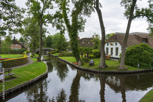 Giethoorn Netherlands Venice of the North canal with old house trees and gardens