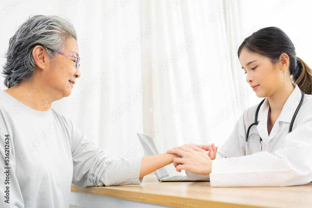Doctor taking the pulse of her senior patient. Doctor taking the pulse of her senior patient.