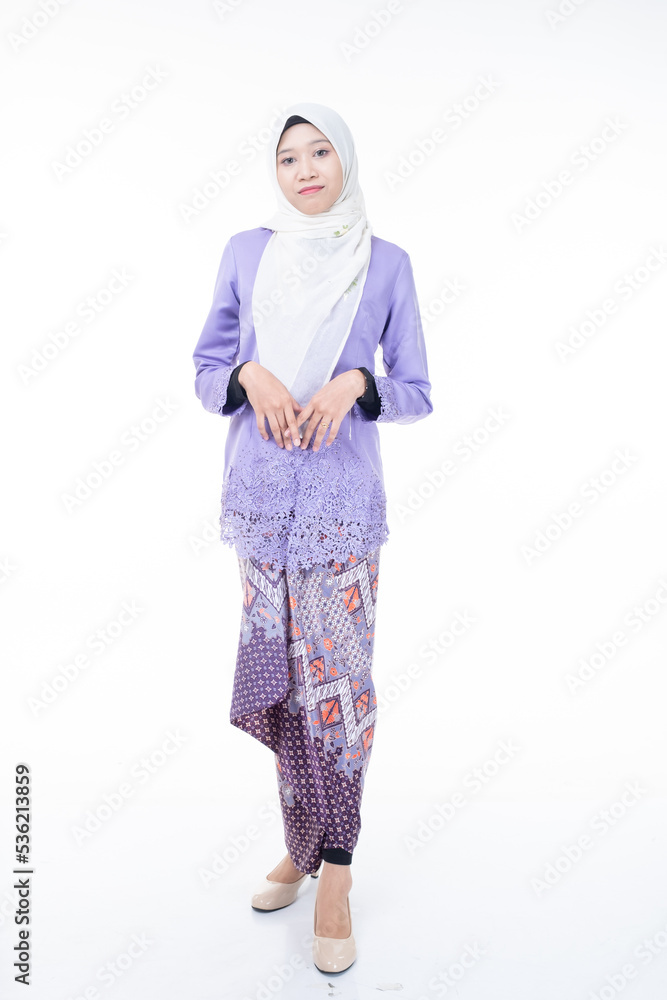 Portrait of a beautiful female model wearing hijab, a lifestyle apparel for Muslim women isolated on brown background. Idul Fitri and hijab fashion concept. Isolated on white background Portrait of a beautiful female model wearing hijab, a lifestyle apparel for Muslim women isolated on brown background. Idul Fitri and hijab fashion concept. Isolated on white background
