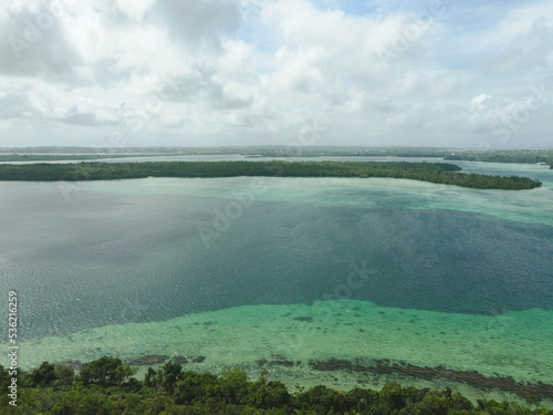 Aerial landscape view of white sea and sunny tropical beach.