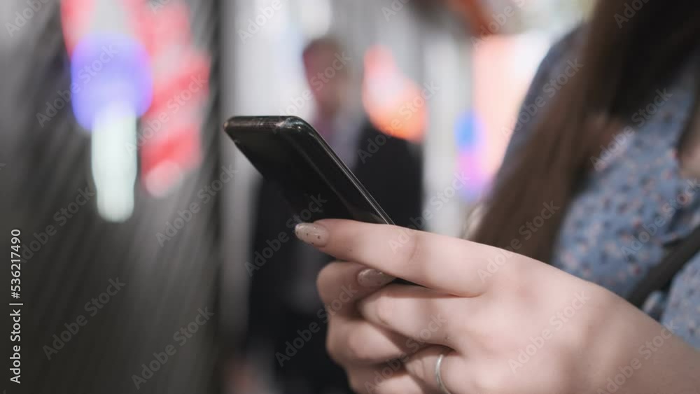 Women holding cell phone using smartphone device in a street cafe. Woman blogger subscribing new social media, buying in internet, ordering products online in apps. Women holding cell phone using smartphone device in a street cafe. Woman blogger subscribing new social media, buying in internet, ordering products online in apps.