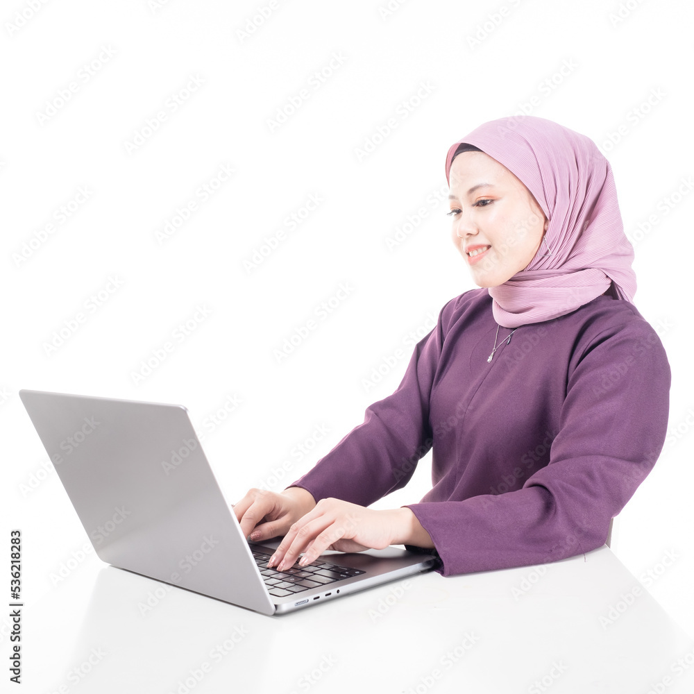 Naklejka premium Young beautiful Asian Islamic businesswoman wearing hijab holding a tablet computer. Women empowerment and leadership concept. Isolated on white background