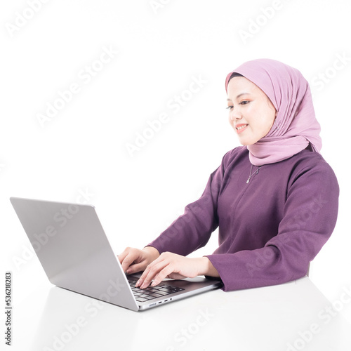 Young beautiful Asian Islamic businesswoman wearing hijab holding a tablet computer. Women empowerment and leadership concept. Isolated on white background