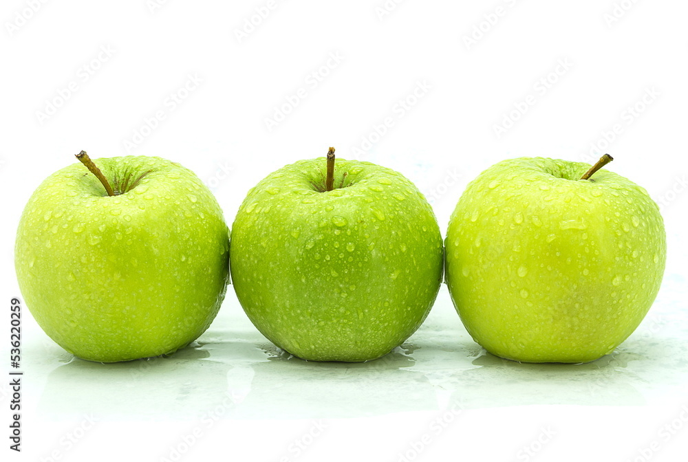 wet green apple on a white background. wet green apple on a white background.