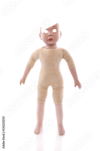 Isolated scary porcelain doll with a cracked head