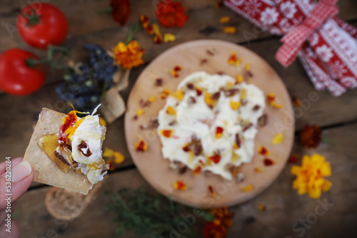 Butter board food trend, cracker with butter and toppings missing a bite