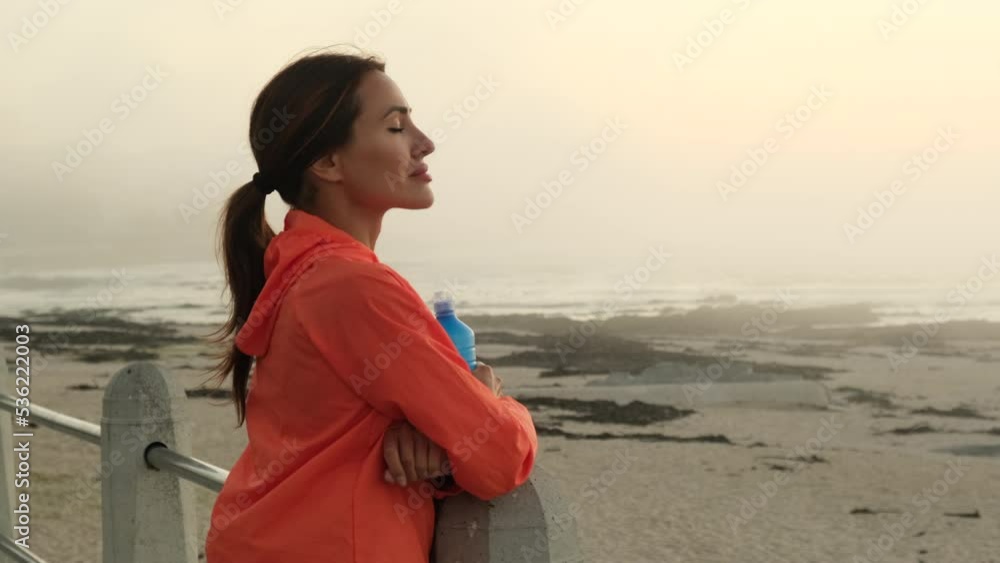 Female athlete relaxing on running track after workout. Runner tired breathing after training looking at her. wearable tech sports watch checking heart rate health data. Exhausted runner resting Female athlete relaxing on running track after workout. Runner tired breathing after training looking at her. wearable tech sports watch checking heart rate health data. Exhausted runner resting