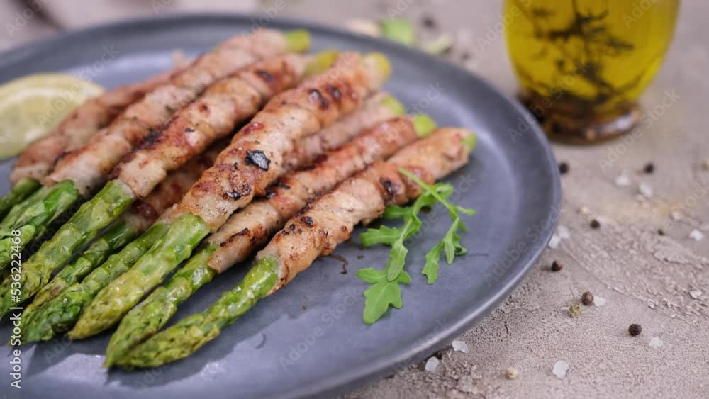 freshly cooked asparagus wrapped with bacon on ceramic plate freshly cooked asparagus wrapped with bacon on ceramic plate