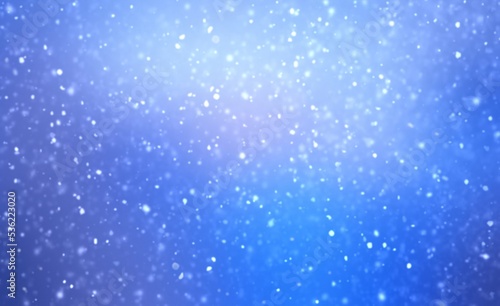 Fluffy snow flakes falls on blue sapphire color empty background. Blur effect. Wonderful winter natural textured backdrop.