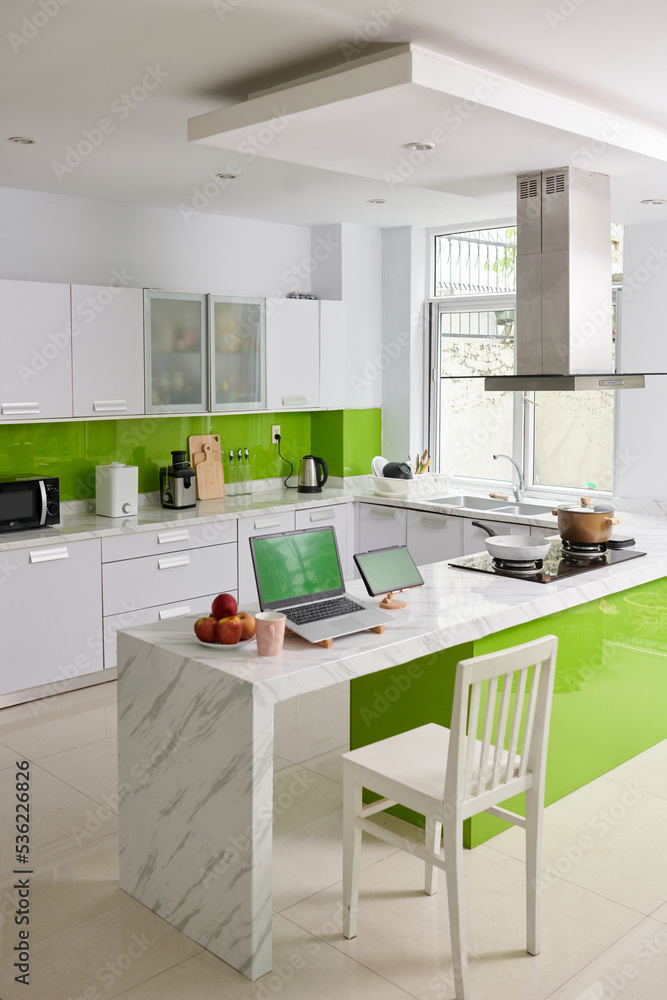 Interior of modern kitchen in spacious apartment with workplace of freelancer Interior of modern kitchen in spacious apartment with workplace of freelancer
