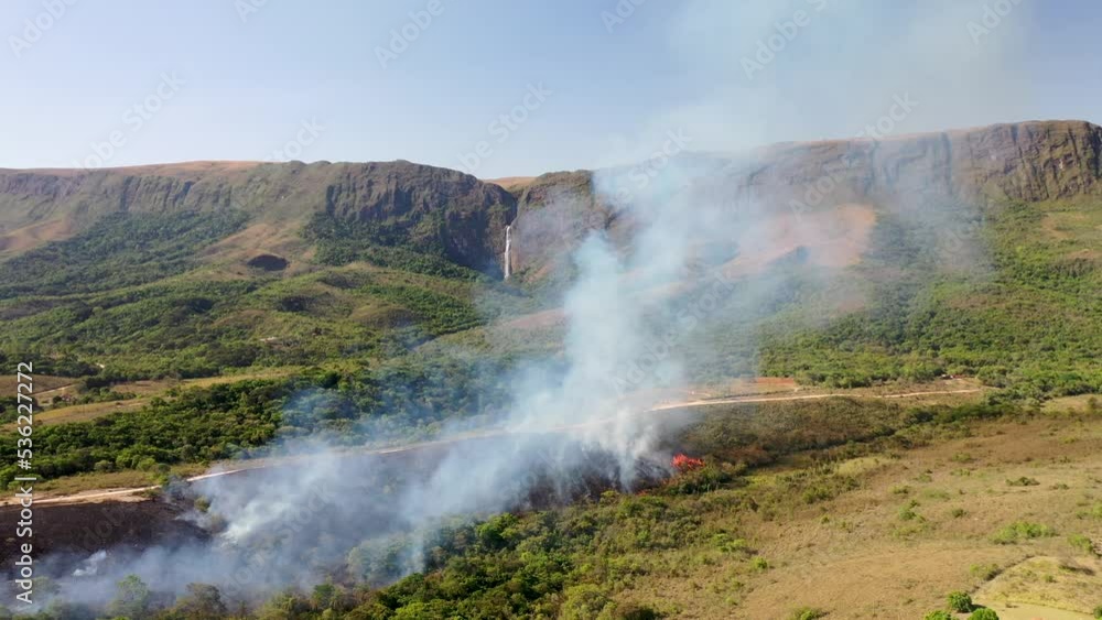 Drone view of Forest fire in Cerrado biome with Atlantic Forest transition near Casca d'Anta waterfall in Serra da Canastra National Park Drone view of Forest fire in Cerrado biome with Atlantic Forest transition near Casca d'Anta waterfall in Serra da Canastra National Park