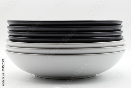 Stack of black and white dishes isolated on white background