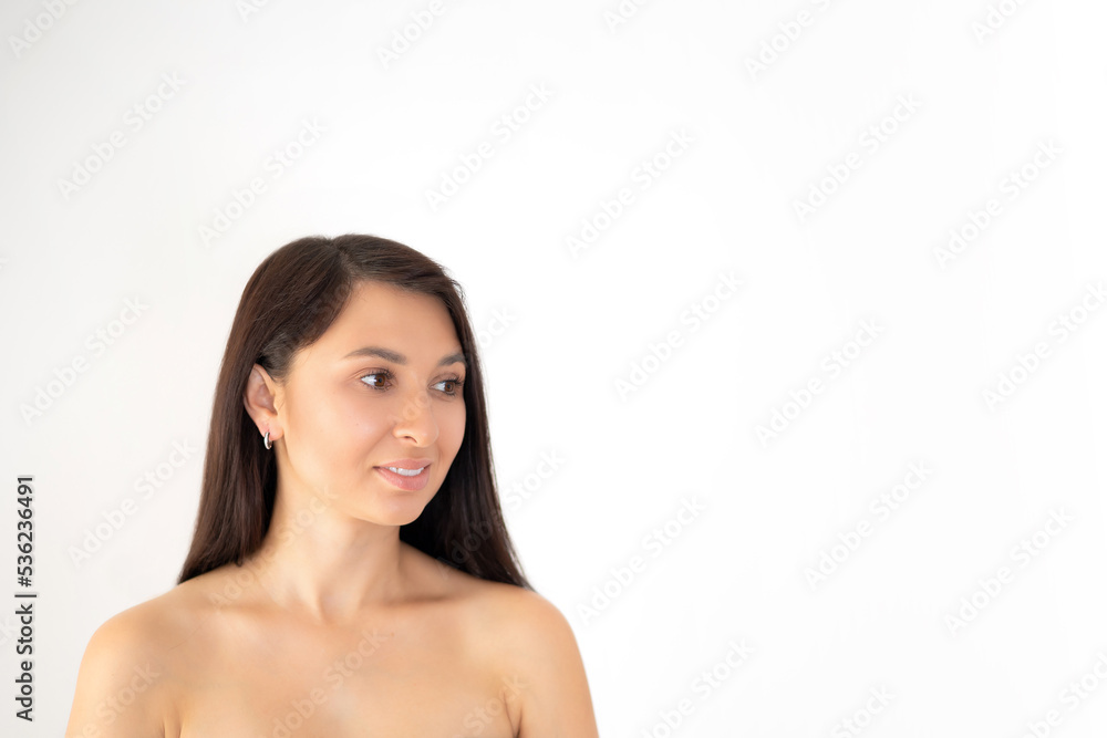 Beautiful young woman brunette with natural beauty and natural makeup on a white background. Space for text. Beautiful young woman brunette with natural beauty and natural makeup on a white background. Space for text.