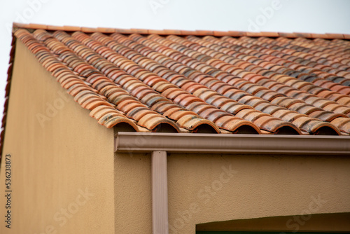 Holder gutter drainage system on home roof residential facade