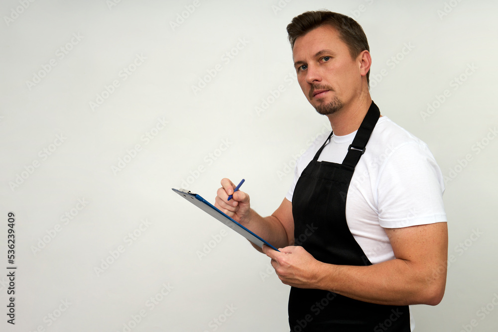 Young man holding paper clipboard on white Young man holding paper clipboard on white