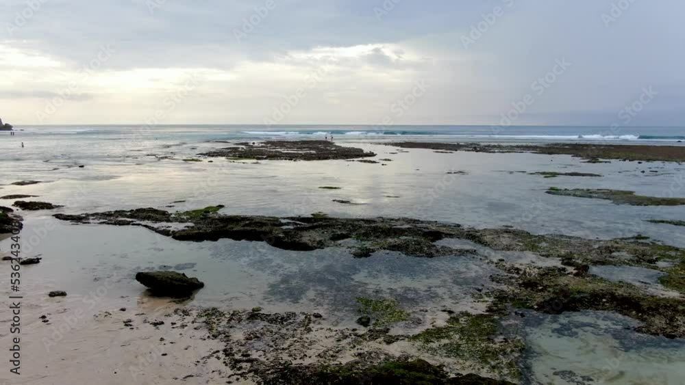 Majestic view of Bali island coastline with crashing waves in horizon, low altitude aerial view Majestic view of Bali island coastline with crashing waves in horizon, low altitude aerial view